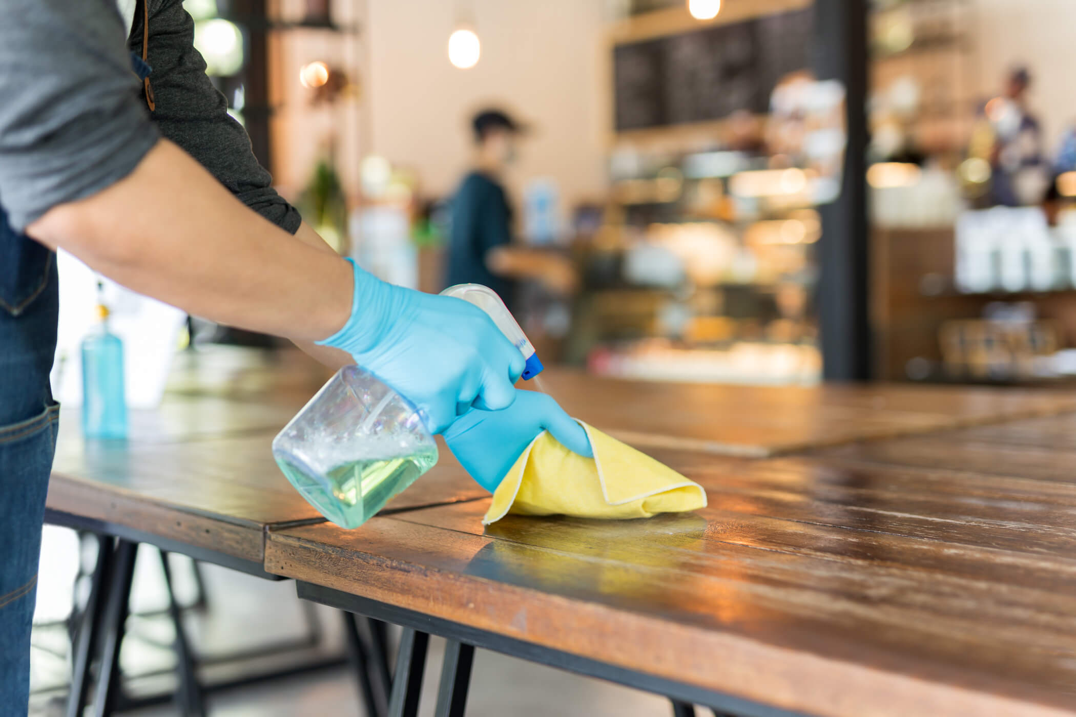 https://officecleaningmiltonkeynes.co.uk/wp-content/uploads/2026/04/waiter-cleaning-table-disinfectant-spray-microfiber.jpeg